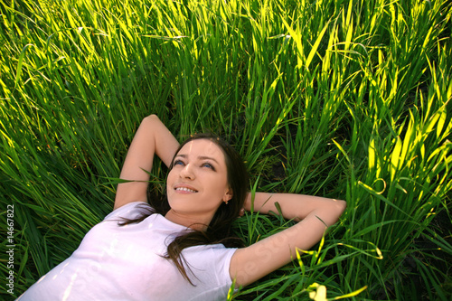 Photo: Pretty smiling girl relaxing outdoor Pretty smiling girl relaxing outdoor