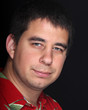 Male portrait on black background with red shirt Male portrait on black background with red shirt