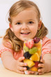 Happy girl with fruit salad or drink
