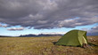 a Tent in front of a Thunderstorm in Iceland