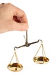 Old scales in a hand on a white background