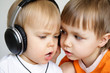 Two singing boys. One with black headphones