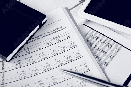 Photo: Monochrome daily financial reports, pen and notepad Monochrome daily financial reports, pen and notepad