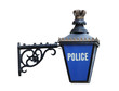 A Vintage Sign Depicting a Police Station Building.