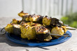 grilled chicken tikka with banana and mint on metal skewer