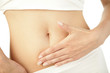 Photo: Closeup of young woman with hand on her stomach Closeup of young woman with hand on her stomach