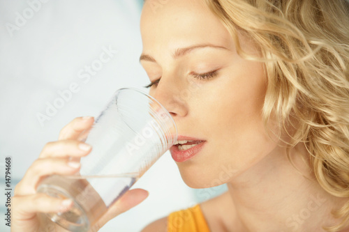 Photo: Young beauty blonde woman drinking mineral water Young beauty blonde woman drinking mineral water