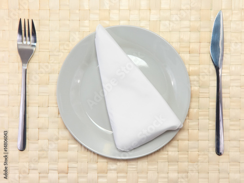 Photo: Table appointments(arrangement) of flatware on bamboo mat. Table appointments(arrangement) of flatware on bamboo mat.