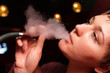 The woman smoking a shisha in a hookah house