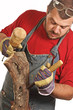 man and sculpture making