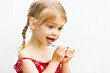 Cute little girl brushing her teeth