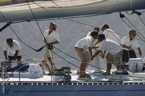 Photo: Crew working on yacht, side view Crew working on yacht, side view