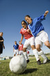 Girls 13-17 playing soccer, low angle view