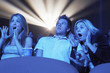 Young People screaming, watching Horror Movie in Theatre