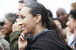 Woman Using Cell Phone in Crowd, side view, head and shoulders