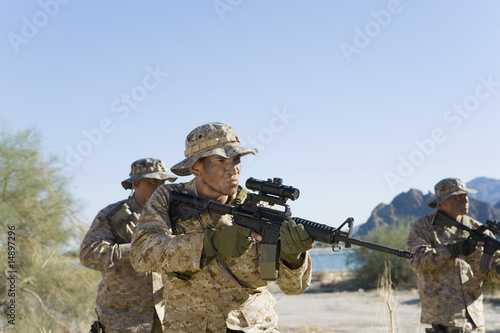 Photo: Soldiers carrying rifles in the field Soldiers carrying rifles in the field