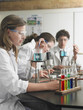 Teenage students caring out experiments in chemistry class