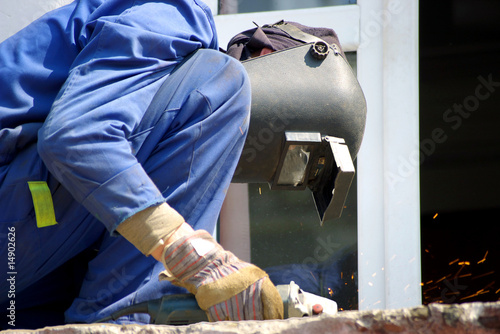 Photo: Worker cuts metal Worker cuts metal
