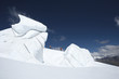 Mountain climbers walking past ice formation