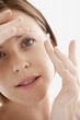 Woman Inserting Contact Lens, close up of face