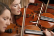 Women Playing Violins in musical group, close-up
