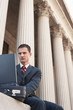 Lawyer using laptop outside courthouse