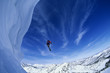Skier jumping from mountain ledge
