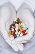 Lab Worker with Hands Full of coloured Pills