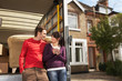 Couple Leaning On Back of Removals Van