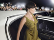 Photo: Woman in evening wear getting out of limousine in front of fans and paparazzi Woman in evening wear getting out of limousine in front of fans and paparazzi