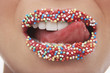 Foto: Tongue licking lips covered in sprinkles Tongue licking lips covered in sprinkles