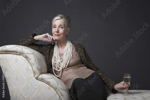 Foto: Mature Woman Having Glass of Champagne Mature Woman Having Glass of Champagne