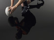 Rugby player kneeling on one knee holding ball, low section with reflection, elevated view