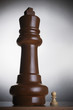Two chess pieces, large king and small pawn