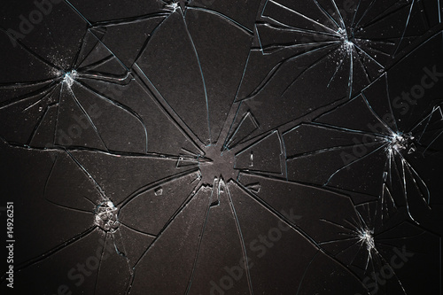 Photo: Broken glass pieced together on black background Broken glass pieced together on black background