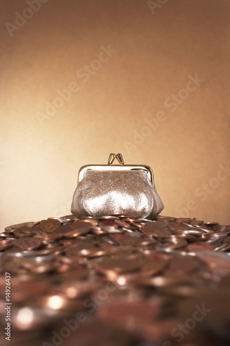 Photo: Bronze purse on heap of copper coins Bronze purse on heap of copper coins