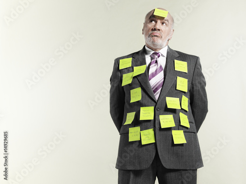 Photo: Businessman covered with sticky notes Businessman covered with sticky notes