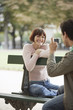 Couple Using Digital Camera in Park