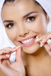 Portrait of beautiful woman with dental floss