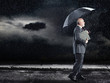 Businessman Walking in rain under umbrella, side view