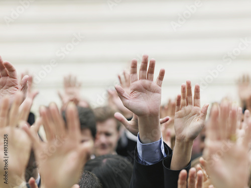 Photo: Crowd of people raising hands, focus on hands Crowd of people raising hands, focus on hands