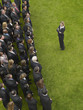 Photo: Business woman facing large group of business people in formation, elevated view Business woman facing large group of business people in formation, elevated view