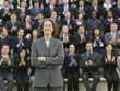Photo: Business woman standing in front of business people sitting in bleachers, clapping, portrait Business woman standing in front of business people sitting in bleachers, clapping, portrait