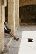 Beggar hidden accordion musician with hat