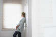 Woman Standing by Bathroom Window