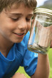 Boy Looking at Snake in Jar