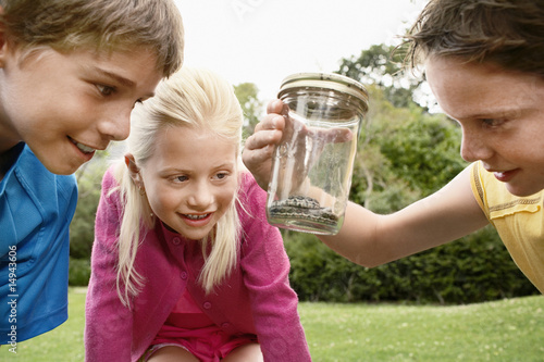 Photo: Children Looking at Snake in Jar Children Looking at Snake in Jar