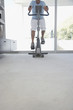 Mature man on exercise bike, pedalling, low section