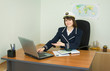 Girl in a sea uniform at table with laptop Girl in a sea uniform at table with laptop