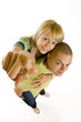 wide angle picture of a young couple pointing to you
